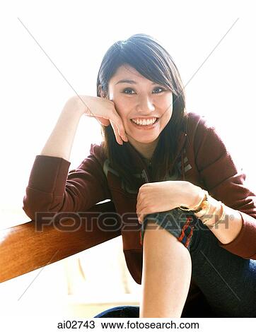 Young woman sitting on chair, portrait. View Large Photo Image Stock Image - Young woman sitting on chair, portrait.. Fotosearch