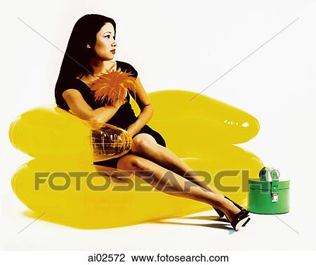 Young woman sitting on yellow inflatable chair, green purse View Large Photo Image Stock Image - Young woman sitting on yellow inflatable chair, green purse. Fotosearch