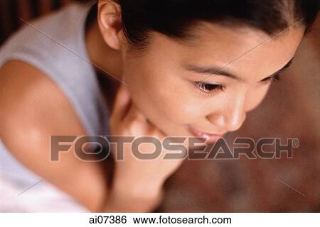 Young woman sitting, with hand on chin, elevated view View Large Photo Image Stock Photograph - Young woman sitting, with hand on chin, elevated view. Fotosearch