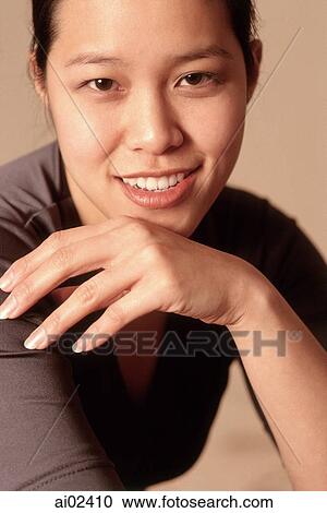 Young woman smiling, portrait View Large Photo Image Stock Image - Young woman smiling, portrait. Fotosearch