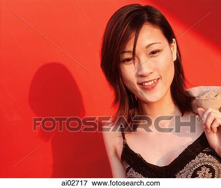 Young woman smiling, red background. View Large Photo Image Stock Photo - Young woman smiling, red background.. Fotosearch
