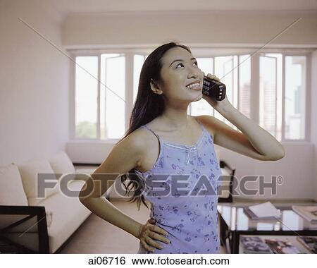 Stock Photograph - Young woman talking on the phone.. Fotosearch