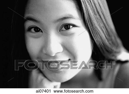 Young woman with hand on chin, smiling. View Large Photo Image Stock Image - Young woman with hand on chin, smiling.. Fotosearch