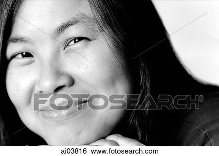 Young woman with hand on chin, smiling View Large Photo Image Stock Photograph - Young woman with hand on chin, smiling. Fotosearch