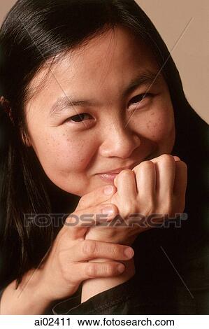 Young woman with hands on chin smiling, portrait View Large Photo Image Stock Image - Young woman with hands on chin smiling, portrait. Fotosearch