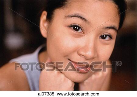 Young woman with hands on chin, smiling. View Large Photo Image Stock Photo - Young woman with hands on chin, smiling.. Fotosearch
