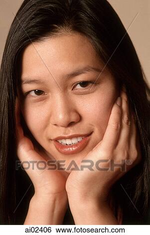 Young woman with hands on chin, smiling, portrait View Large Photo Image Stock Photograph - Young woman with hands on chin, smiling, portrait. Fotosearch