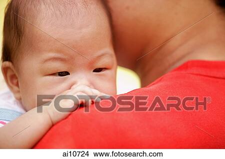 Picture - Baby being carried by father. Fotosearch