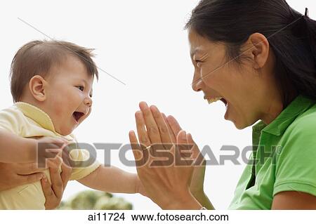 Baby girl facing her mother View Large Photo Image Picture - Baby girl facing her mother. Fotosearch