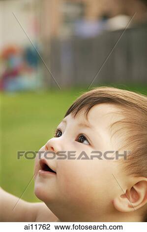 Stock Image - Baby girl, looking up. Fotosearch