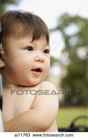 Baby girl, standing, looking away View Large Photo Image Stock Image - Baby girl, standing, looking away. Fotosearch