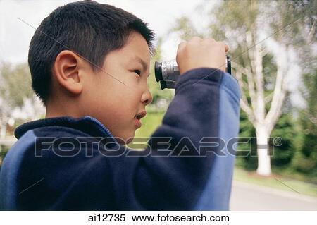 Boy looking through binoculars View Large Photo Image Stock Photography - Boy looking through binoculars. Fotosearch