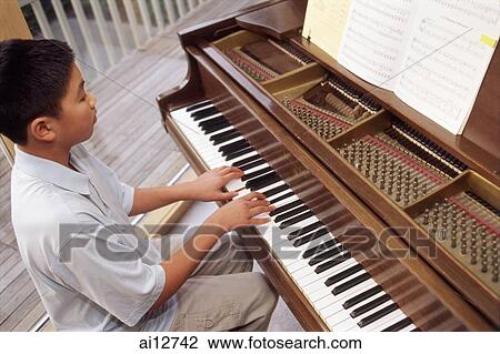 Boy playing the piano View Large Photo Image Stock Image - Boy playing the piano. Fotosearch
