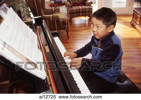 Boy playing the piano. View Large Photo Image Stock Photography - Boy playing the piano.. Fotosearch