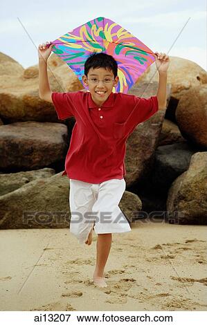 Boy running with kite View Large Photo Image Stock Photo - Boy running with kite. Fotosearch
