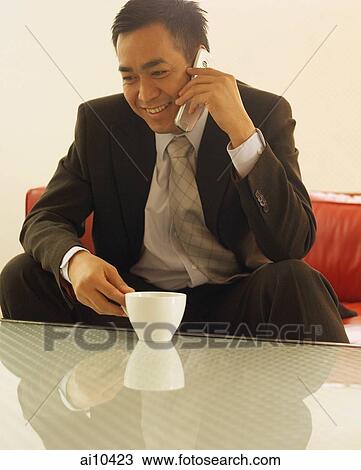 Businessman on mobile phone, smiling View Large Photo Image Stock Image - Businessman on mobile phone, smiling. Fotosearch