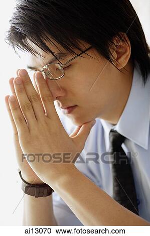 Stock Image - Businessman resting head on hand, portrait. Fotosearch