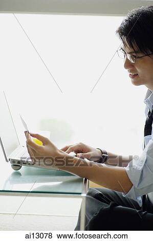 Businessman with documents and laptop View Large Photo Image Stock Photo - Businessman with documents and laptop. Fotosearch