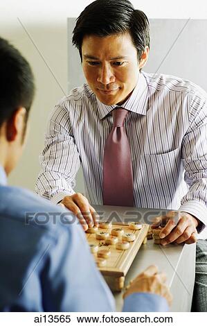 Stock Photography - Businessmen playing chess. Fotosearch