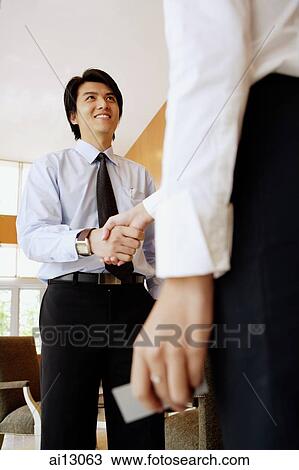 Businesswoman and businessman shaking hands View Large Photo Image Stock Image - Businesswoman and businessman shaking hands. Fotosearch