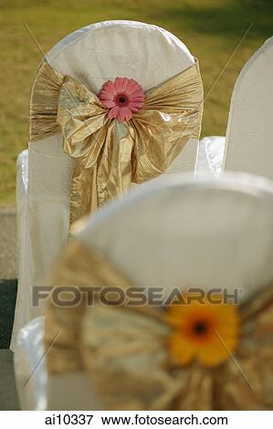 Stock Photo - Chairs with ribbons around them. Fotosearch