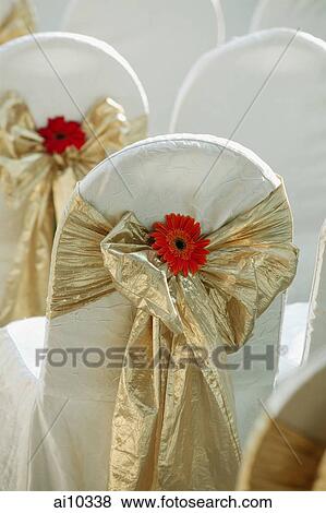 Stock Photo - Chairs with ribbons around them. Fotosearch
