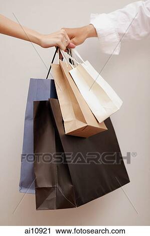 Close- up of hands holding shopping bags View Large Photo Image Stock Image - Close- up of hands holding shopping bags. Fotosearch