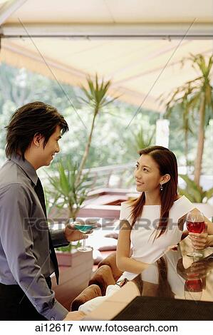 Couple at bar counter, with drinks View Large Photo Image Stock Photo - Couple at bar counter, with drinks. Fotosearch