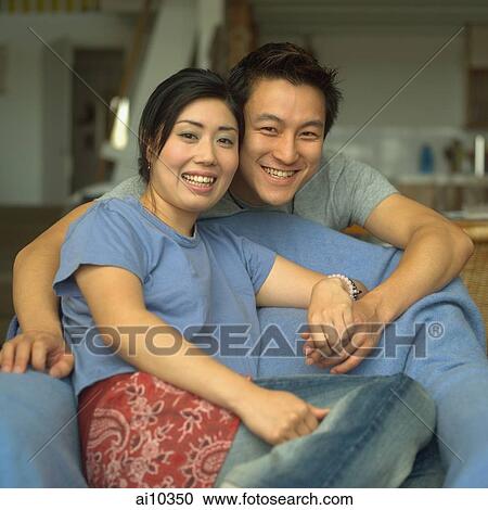 Couple at home, looking at camera, smiling View Large Photo Image Stock Image - Couple at home, looking at camera, smiling. Fotosearch