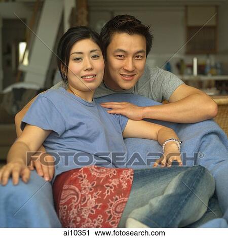 Stock Image - Couple at home, looking at camera. Fotosearch