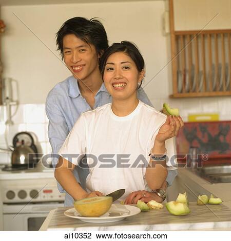 Couple at home, standing in kitchen View Large Photo Image Stock Image - Couple at home, standing in kitchen. Fotosearch