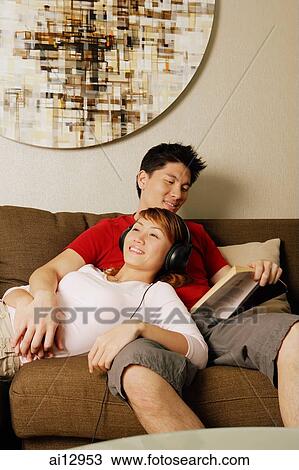 Couple at home, woman lying on man's lap View Large Photo Image Stock Image - Couple at home, woman lying on man's lap. Fotosearch