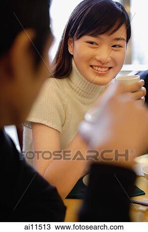 Couple at restaurant, holding teacups View Large Photo Image Stock Image - Couple at restaurant, holding teacups. Fotosearch