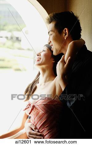 Couple at window, embracing View Large Photo Image Stock Image - Couple at window, embracing. Fotosearch