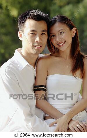 Couple embracing, looking at camera, portrait View Large Photo Image Picture - Couple embracing, looking at camera, portrait. Fotosearch