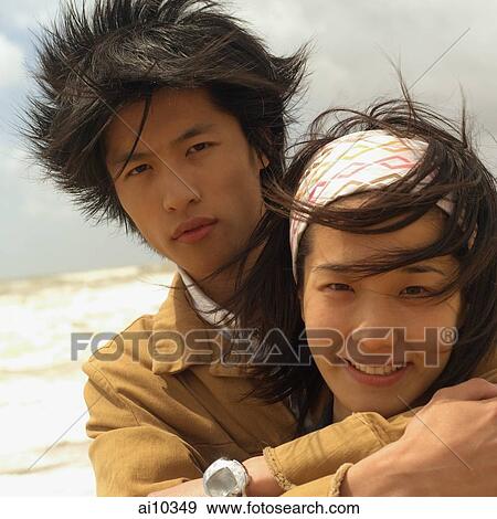 Stock Photo - Couple embracing, looking at camera. Fotosearch