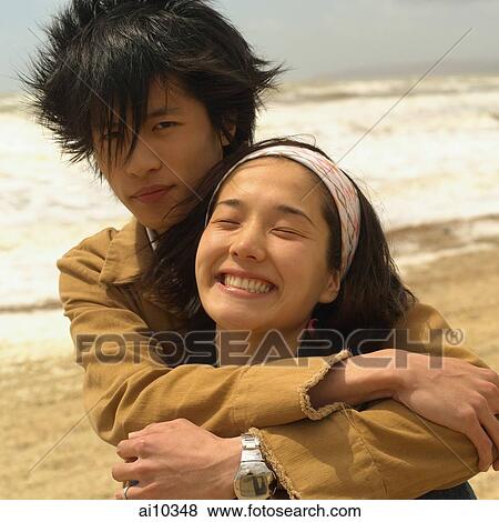 Couple embracing on beach View Large Photo Image Stock Photo - Couple embracing on beach. Fotosearch