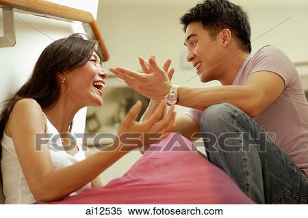 Couple facing each other, hands raised View Large Photo Image Stock Photography - Couple facing each other, hands raised. Fotosearch