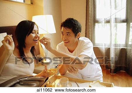 Couple having breakfast in bed View Large Photo Image Stock Image - Couple having breakfast in bed. Fotosearch