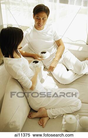 Couple having coffee, looking at each other View Large Photo Image Stock Photography - Couple having coffee, looking at each other. Fotosearch