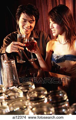 Couple having drinks at night club View Large Photo Image Picture - Couple having drinks at night club. Fotosearch