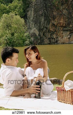 Couple having picnic by a lake View Large Photo Image Stock Image - Couple having picnic by a lake. Fotosearch