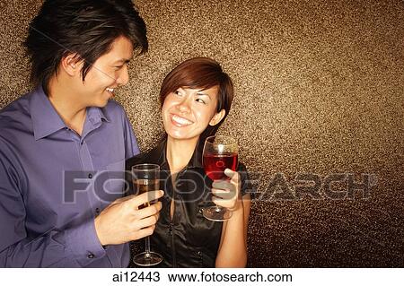 Couple holding drinks, looking at each other View Large Photo Image Stock Image - Couple holding drinks, looking at each other. Fotosearch