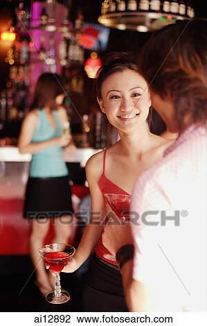 Couple holding drinks, talking View Large Photo Image Stock Image - Couple holding drinks, talking. Fotosearch