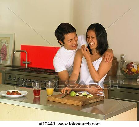 Couple in kitchen, embracing View Large Photo Image Stock Photo - Couple in kitchen, embracing. Fotosearch