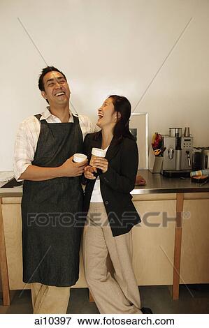Couple in kitchen, laughing View Large Photo Image Stock Photo - Couple in kitchen, laughing. Fotosearch