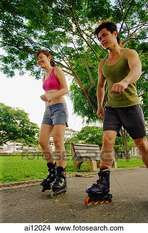 Couple inline skating at park View Large Photo Image Picture - Couple inline skating at park. Fotosearch