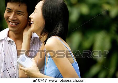Couple listening to MP3 player View Large Photo Image Stock Photo - Couple listening to MP3 player. Fotosearch