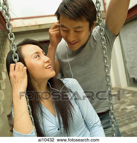 Couple listening to personal stereo View Large Photo Image Stock Image - Couple listening to personal stereo. Fotosearch