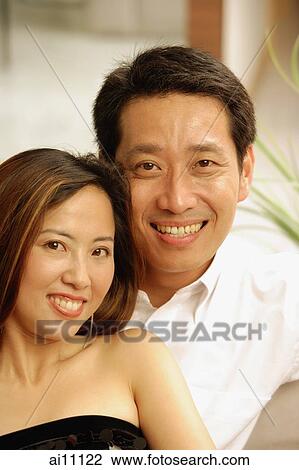 Couple looking at camera, portrait View Large Photo Image Stock Image - Couple looking at camera, portrait. Fotosearch